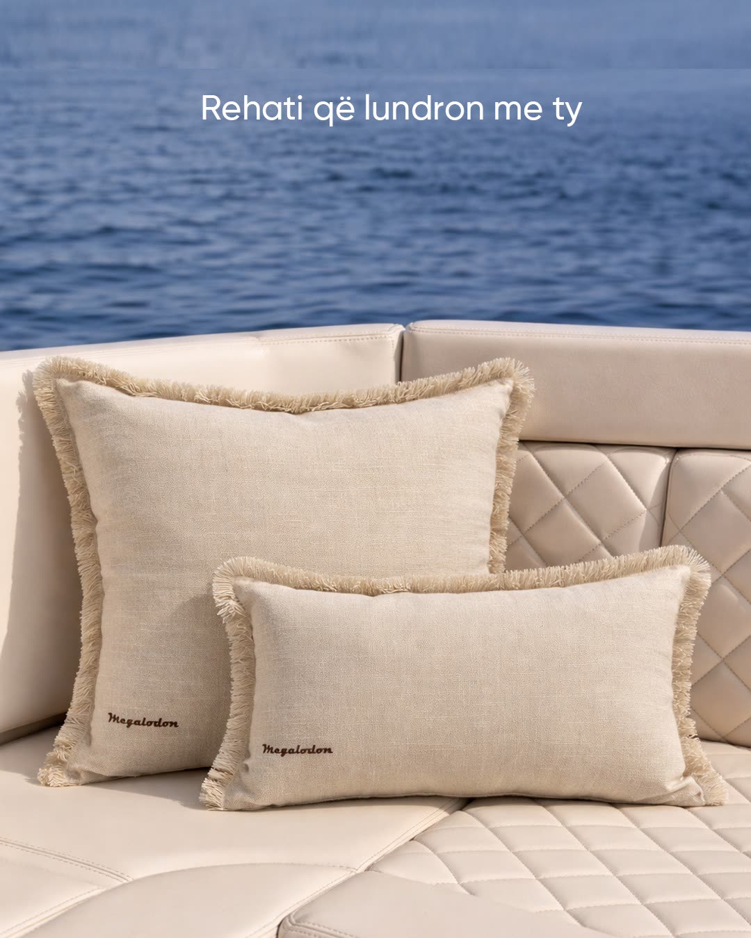 Fringed cushions bearing the Megalodon name on a quilted sunpad